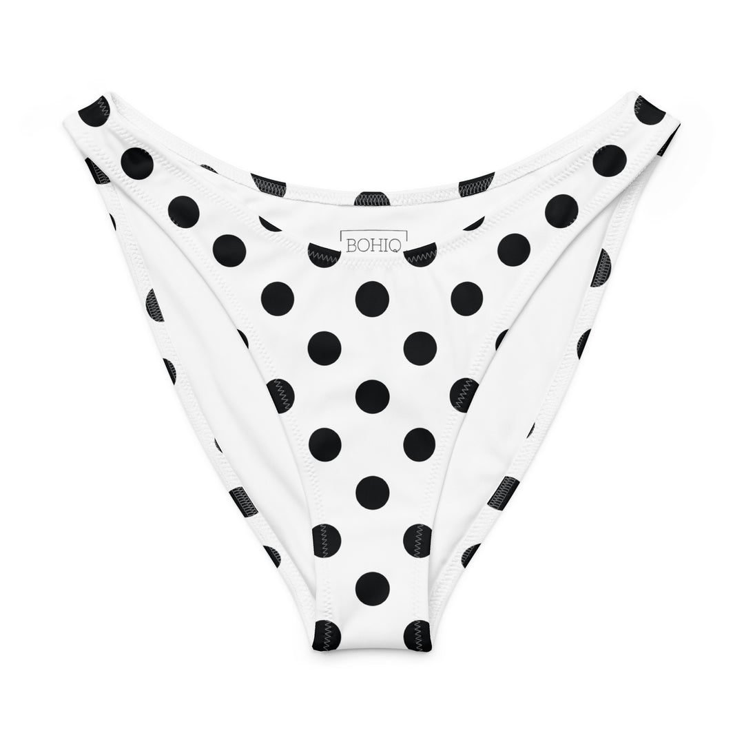 White bikini bottom with black polka dots on a white background