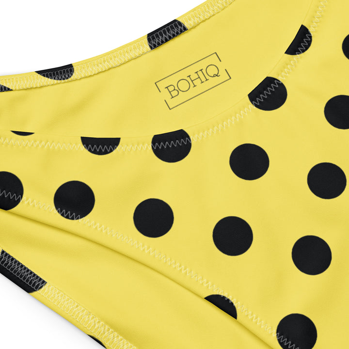 Yellow bikini bottom with black polka dots and 'BOHQ' branding.